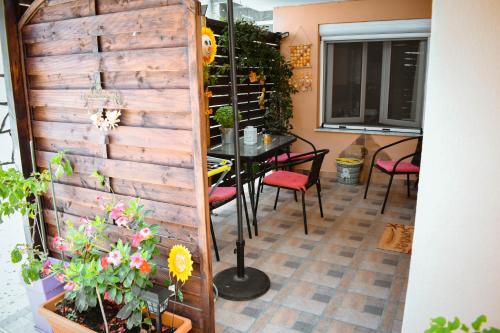a dining room with a table and chairs and a wall at Teo Apartments Luxury ll in Kavala