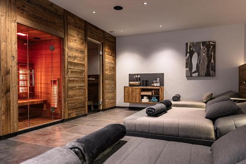 a living room with a bed and a television at DAS MORITZ- Fine Living Apartments in Nauders