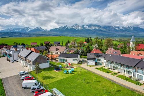 an aerial view of a small town with mountains in the background at Apartments Čerešňový Sad & Wellness in Mengusovce