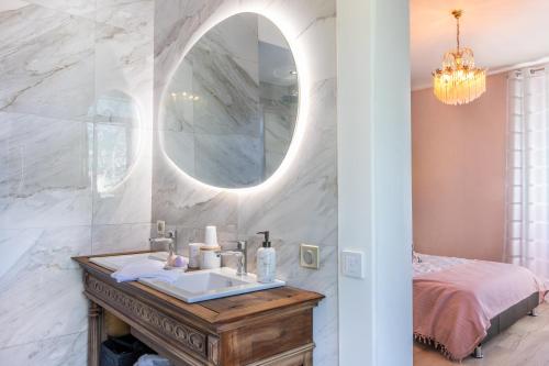 a bathroom with a sink and a mirror at le clos grillet in La Chambre