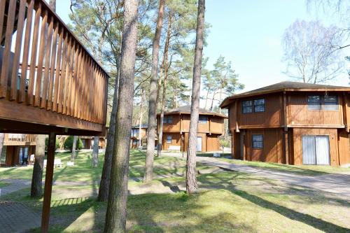 a couple of buildings with trees in front of them at Hotel Residenz WALDOASE in Ahlbeck