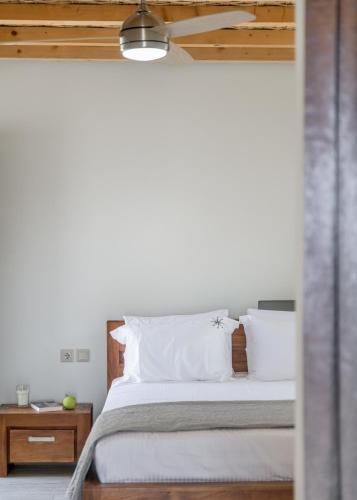a bedroom with a large bed with white pillows at Casa del Mar Milos in Areti