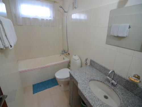 a bathroom with a sink and a toilet and a tub at Hotel Asia in Pokhara