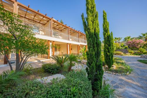 a large building with trees in front of it at Kairos Valley Health & Nature Resort in Datca