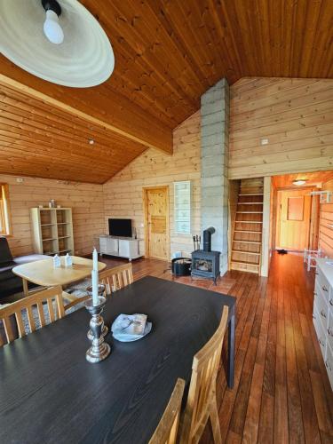 a dining room with a table in a wooden room at Nice Sirdal Bungalow in Ådneram in Ådneram
