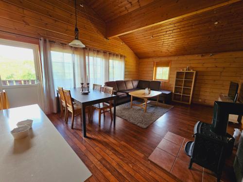 a living room with a table and a couch at Nice Sirdal Bungalow in Ådneram 