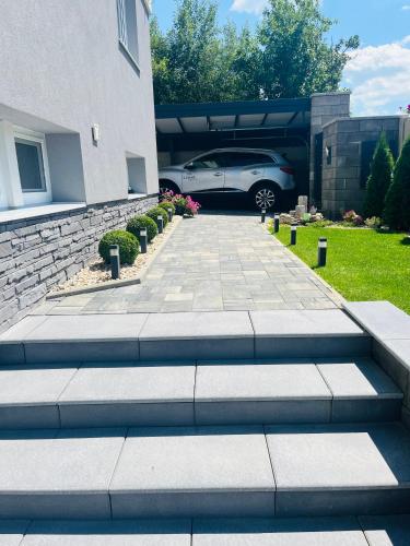 a car parked in front of a house at Vila LEMAR wellness & spa in Huncovce