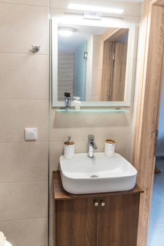 a bathroom sink with a mirror and a shower at Emmanouela Apartment in Matala