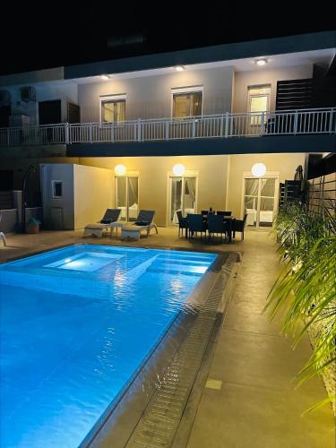 a large swimming pool in front of a house at Flev's Luxury House with pool in Kremasti