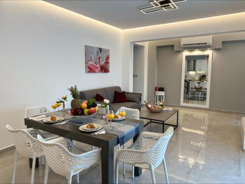 a living room with a table and chairs at Flev's Luxury House with pool in Kremasti