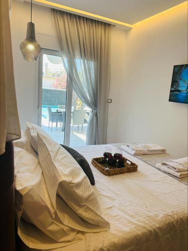 a bedroom with a bed with a tray of food on it at Flev's Luxury House with pool in Kremasti