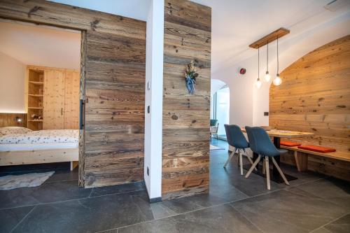 a wooden sliding door in a room with a bedroom at Apartments Smidl in Ortisei