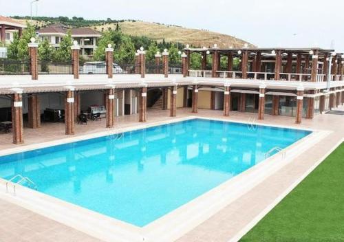 a large swimming pool in front of a building at A Scenic villa near Airport in Büyükçekmece