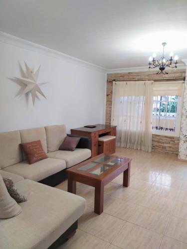 a living room with a couch and a coffee table at Casa Sagittarius Ocean view in San Marcos