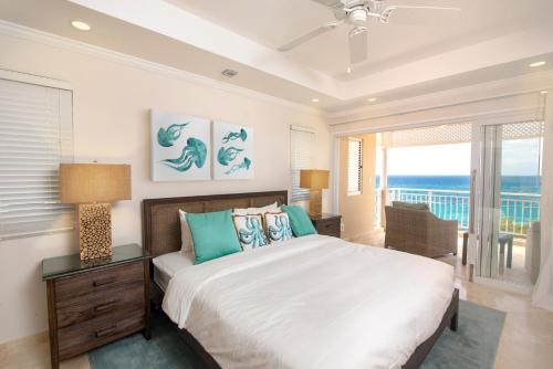 a bedroom with a bed and a view of the ocean at The Crane Resort in Saint Philip