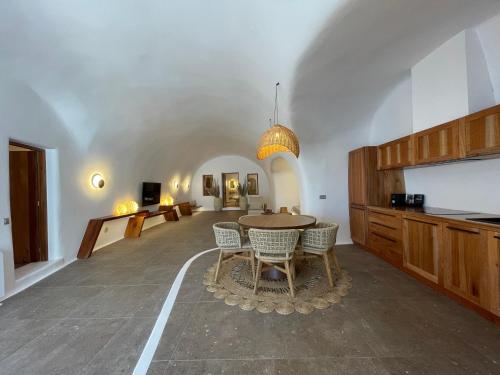 a kitchen with a table and chairs in a room at Victoria Caves in Vóthon