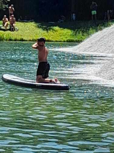 a man on a surfboard in the water at Paulinio in Jajce