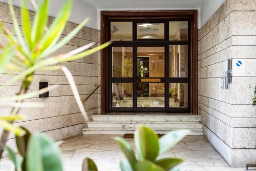 a glass door on a building with plants at Glamroom Vatican Apartment in Rome