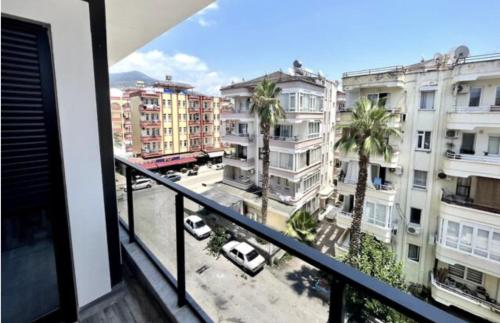 a balcony with a view of a city with buildings at New apartment by Cleopatra in Alanya