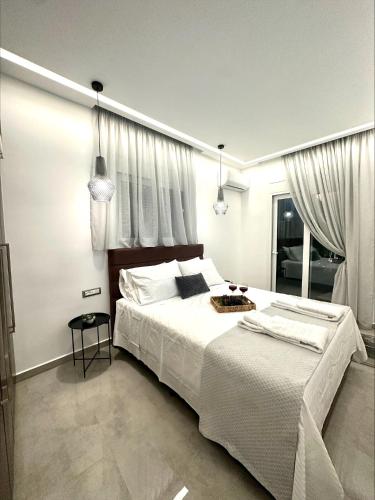 a bedroom with a large bed with white sheets at Flev's Luxury House with pool in Kremasti