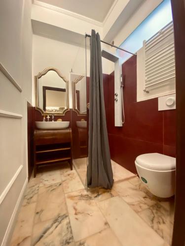 a bathroom with a toilet and a sink and a mirror at Don Ciccio GH in Bova Marina