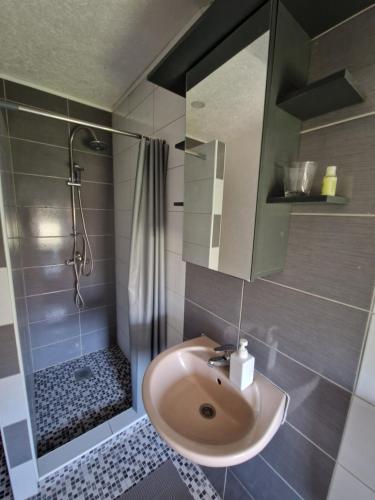 a bathroom with a sink and a shower at Sweet guesthouse in Mostar
