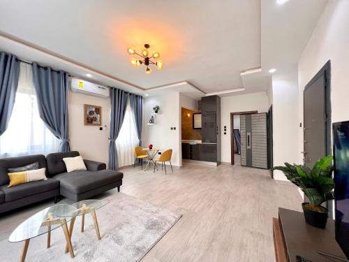 a living room with a couch and a table at Lindsay Apartments - Diamond Block in Accra