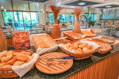 a buffet with baskets of bread on a counter at Calimera Ralitsa Superior Hotel - Ultra All Inclusive plus Aquapark in Albena