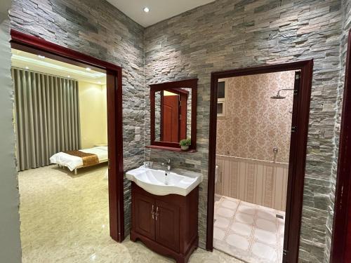 a bathroom with a sink and a shower at شقة فاخرة غرفتين وصالة النرجس ١٣ in Riyadh