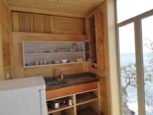 a kitchen with a sink and a counter with a window at Mawo house in Santana