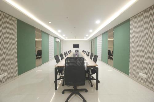 a conference room with a long table and chairs at Hotel SSR GRAND in Hyderabad