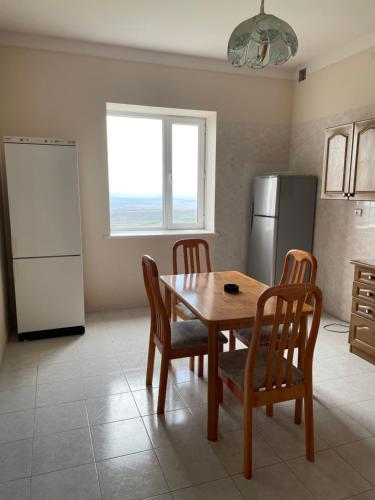 a kitchen with a table and chairs and a refrigerator at Lernarot Guest House 