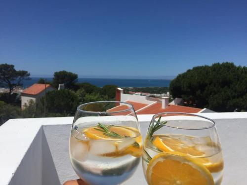 two glasses of water and oranges on a ledge at Casa Capuchos. Close to Lisbon with Ocean View in Caparica