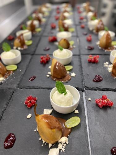 a row of desserts on a table with toppings at Hotel Sonnenhügel in Bad Bevensen