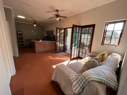 ein Wohnzimmer mit einem Sofa und einer Küche in der Unterkunft Casa Bravo - Cozy Traveller in Pretoria