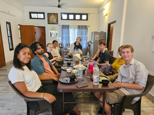 a group of people sitting around a table at Bhaskar Homestay in Dibrugarh