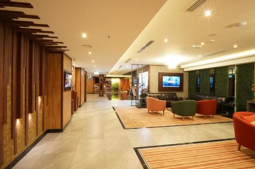 a lobby of a hotel with chairs and a bar at Concorde Palace Hotel in Dubai