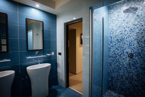 a bathroom with a shower and a toilet and a sink at LH Hotel&SPA in Lviv