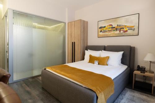 a bedroom with a large bed and a window at The Dome Hotel in Satu Mare
