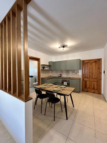a dining room with a table and chairs in a kitchen at Sliema Apartment in Sliema