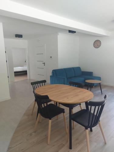 a room with a table and chairs and a couch at Apartament na Osiedlu Zielone Zarabie in Myślenice