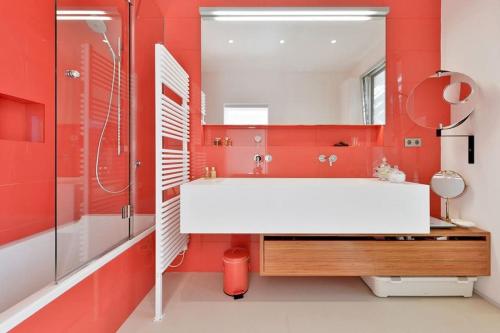 a bathroom with a white sink and red walls at Mordern Villa - Sea view - Near Eivissa old town in Can Furnet