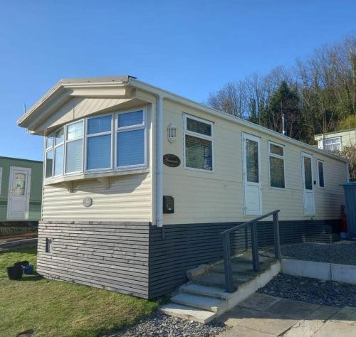 a mobile home is parked in a yard at Wonderful 2 bedroom mobile home in Aberystwyth