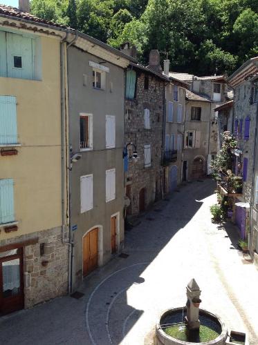 an alley with buildings and a fire hydrant on a street at L'Auberge De Montpezat in Montpezat-sous-Bauzon