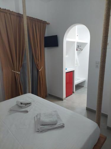 a room with a bed and a room with a window at Golden Star Praxitelous in Agia Marina Aegina