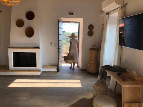 a woman standing in a room with a door open at Villa Vager Mani Hotel in Kalamata