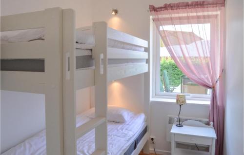 a bedroom with two bunk beds and a window at 2 Bedroom Gorgeous Home In Malmkping in Malmköping