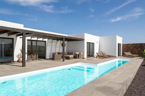 an image of a villa with a swimming pool at Villa Alfa by FuerteventuraVillas in Lajares