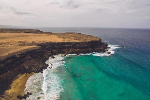 an aerial view of a beach and the ocean at Villa Alfa by FuerteventuraVillas in Lajares