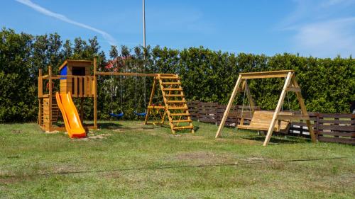 two childrens playground equipment in a yard at RYBY W SIECI in Władysławowo